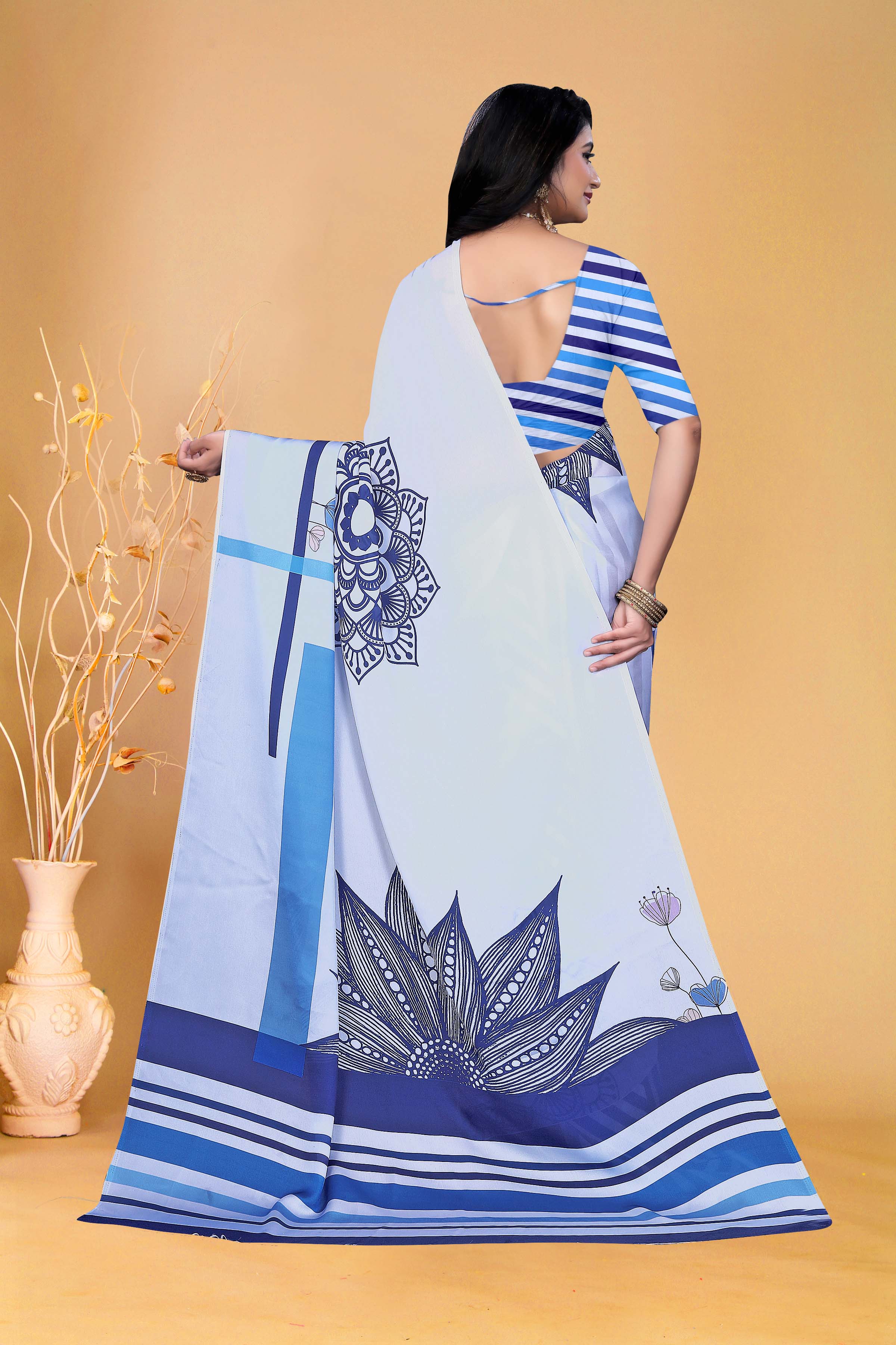 Graceful Sky Blue Printed Saree with Contemporary Striped Blouse