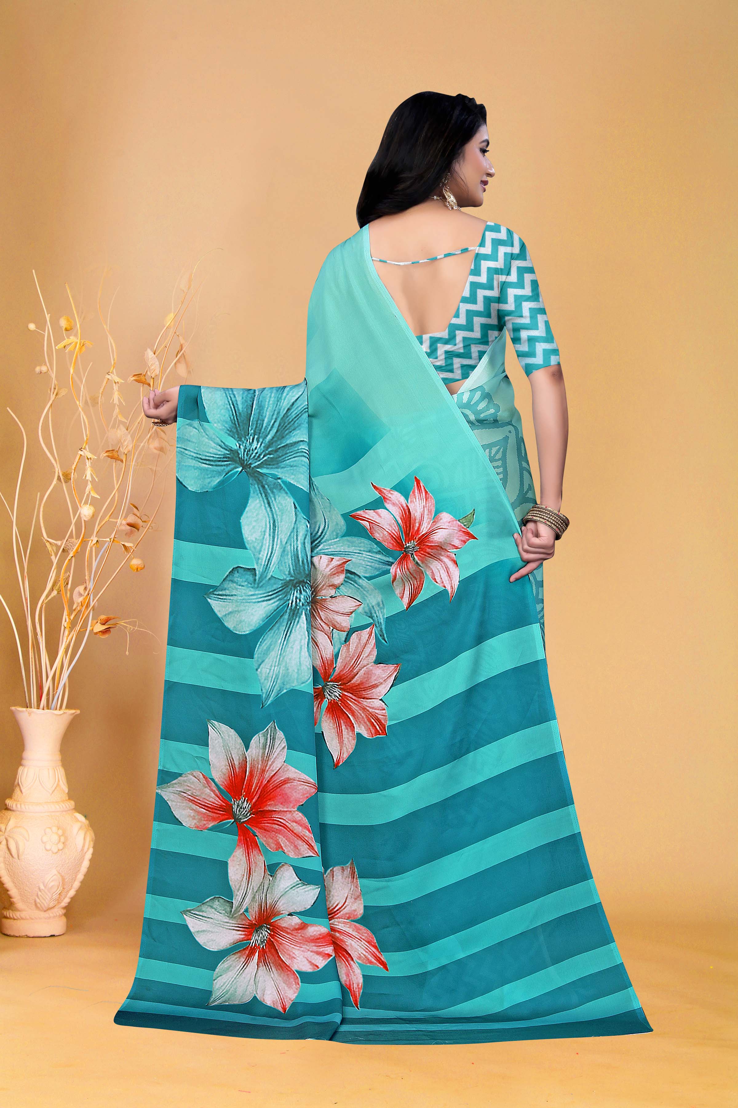 Elegant Teal Floral Saree with Zigzag Blouse Design