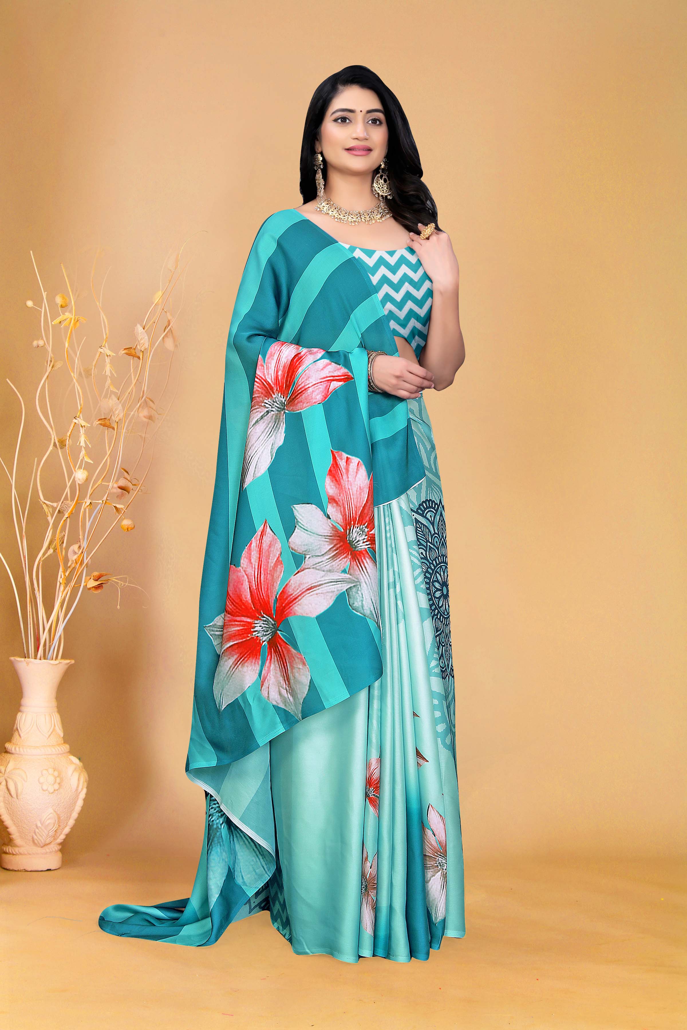 Elegant Teal Floral Saree with Zigzag Blouse Design
